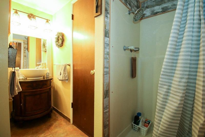 8053 South Rio Avenue Reedley, CA 93654 - Photo 10 of 30 a bathroom with a sink and a mirror