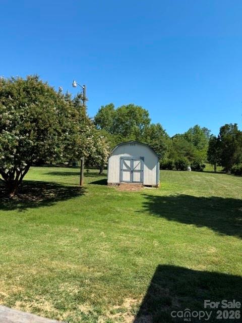 4084 Carpenters Cove Road Claremont, NC 28610 - Photo 19 of 27 a view of a garden with a house in the background