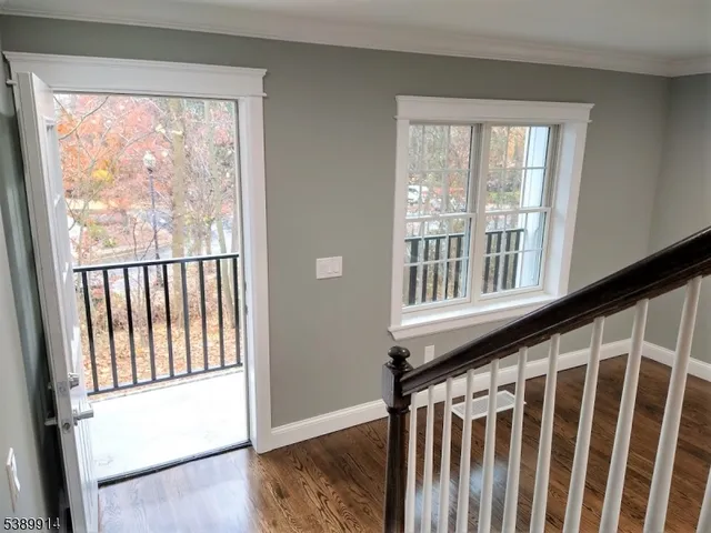 a view of a porch with wooden floor and a window