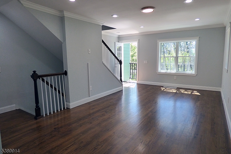34 Walnut Street Madison, NJ 07940 - Photo 3 of 18 a view of an empty room with wooden floor and a window