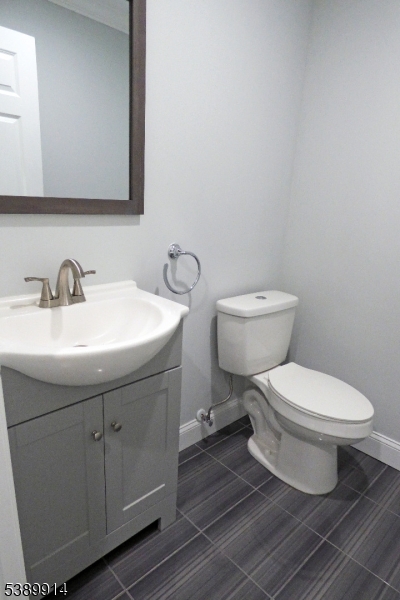 34 Walnut Street Madison, NJ 07940 - Photo 5 of 18 a bathroom with a toilet sink and mirror