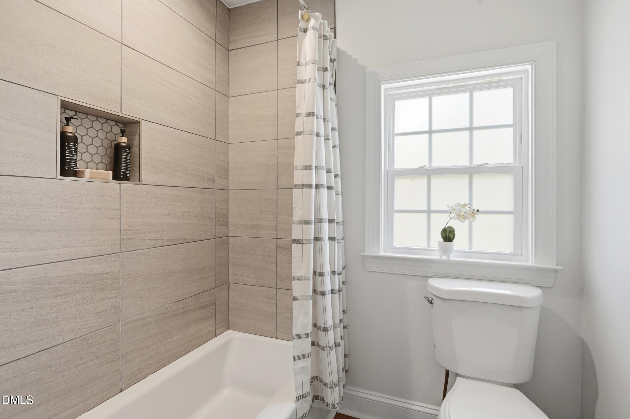 2301 Milburnie Road Raleigh, NC 27610 - Photo 11 of 23 a bathroom with a toilet and bathtub