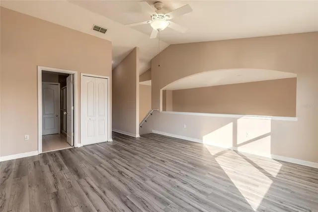 a view of an empty room and wooden floor