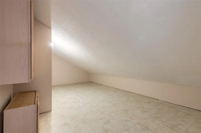 an empty room with wooden floor and a large window