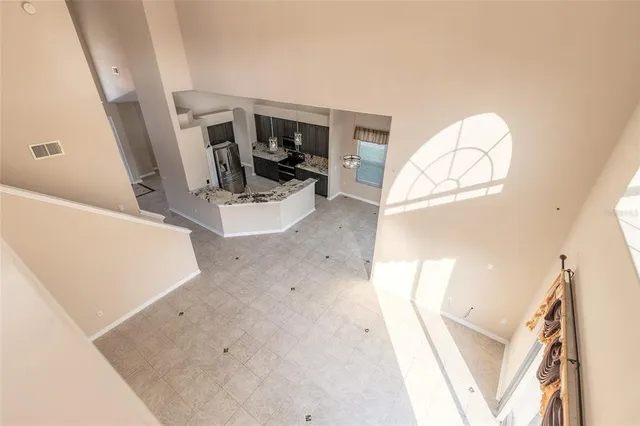 a view of an empty room with a fireplace and a large window