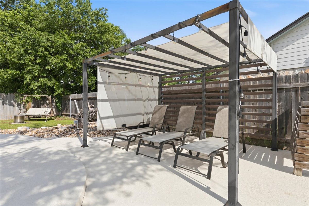 12400 Rusted Nail Cove Austin, TX 78750 - Photo 28 of 31 The pergola-covered seating area adds shade and comfort to the backyard setup.