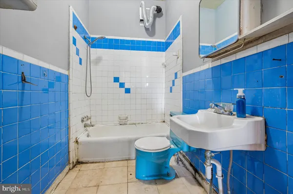 a bathroom with a sink a toilet and bathtub