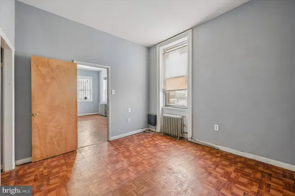 an empty room with windows and closet