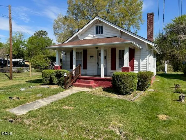a front view of a house with a yard table and chairs