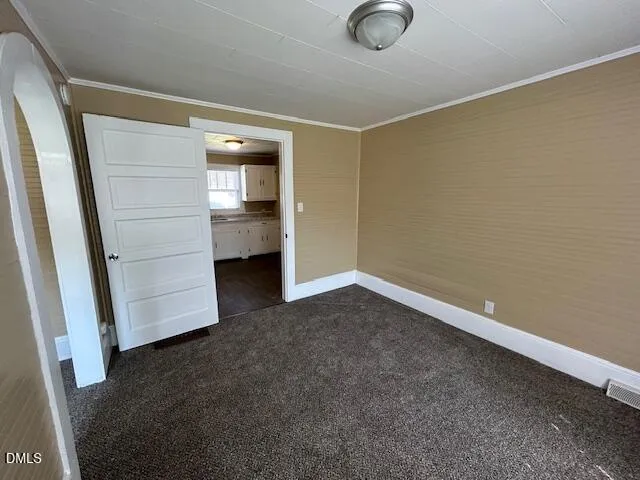 a view of an empty room with closet