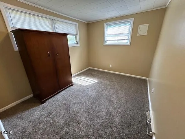 an empty room with wooden floor and closet