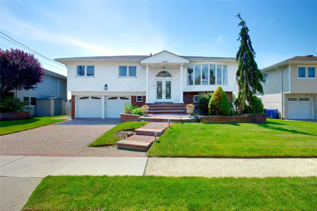 a front view of house with yard and green space