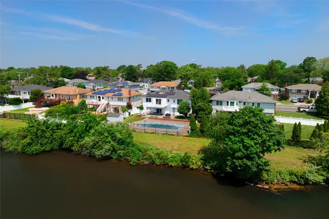 an aerial view of multiple houses with yard
