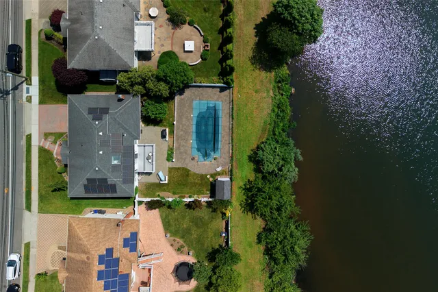 an aerial view of a house with swimming pool and garden