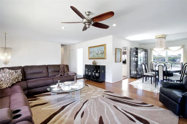 a living room with furniture kitchen view and a fireplace