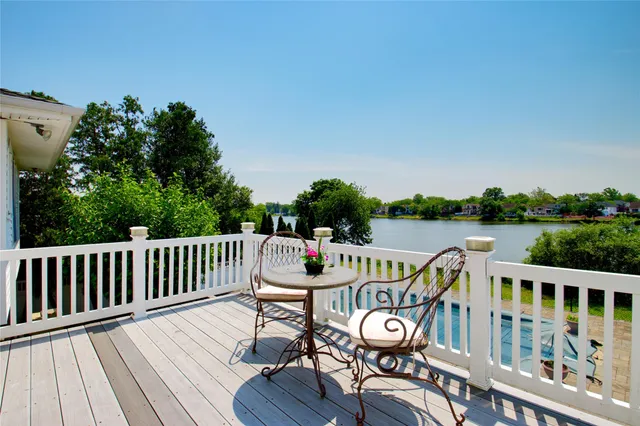 a view of a roof deck with furniture
