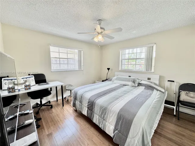 a bedroom with a bed and a desk