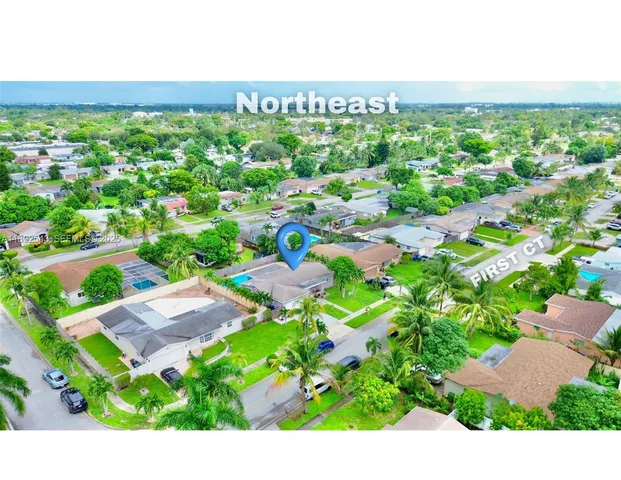 an aerial view of residential houses with outdoor space and street view