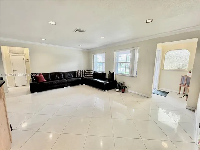 a living room with a couch and a large window