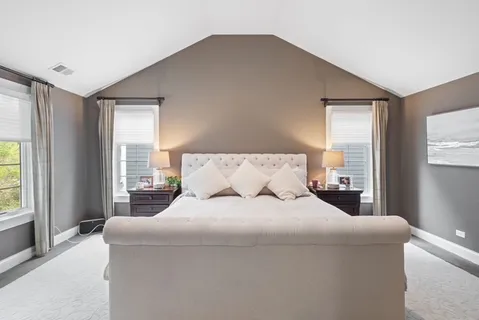 a bedroom with a large bed and a large window