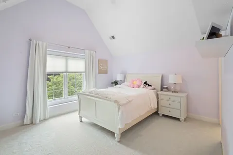 a bed room with a bed and a window