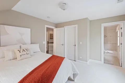 a spacious bedroom with a bed and a shower