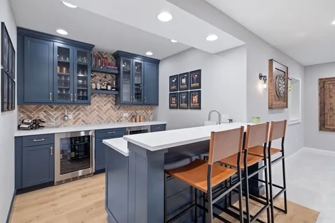 a kitchen with stainless steel appliances kitchen island granite countertop a sink and cabinets