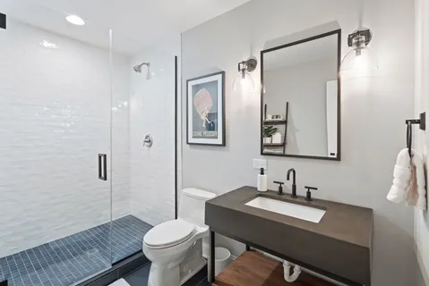 a bathroom with a sink toilet and shower