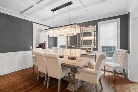 a dining room with furniture wooden floor and a chandelier