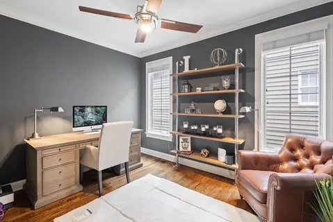 a living room with furniture cabinets and window