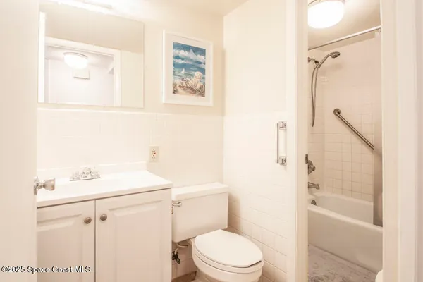 a white toilet sitting next to a bathroom sink