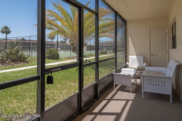 a room with a large window and sitting area