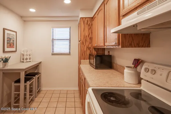 a kitchen with a stove a sink and a refrigerator