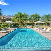 a view of a swimming pool with lounge chairs in patio
