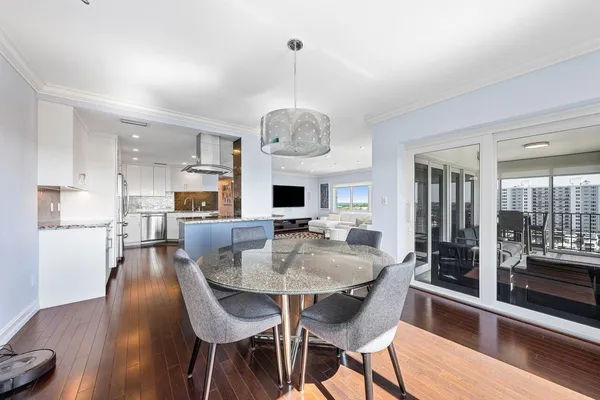 a dining room with furniture a chandelier and wooden floor