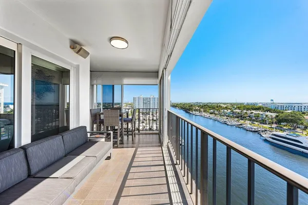 a balcony with furniture and a table
