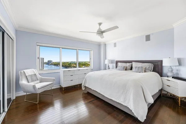 a bedroom with a bed and a large window