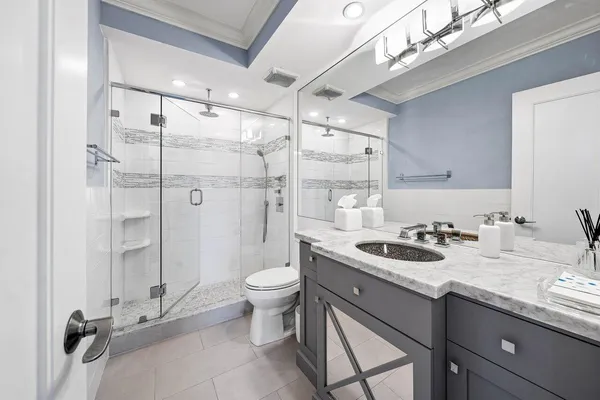 a bathroom with a sink toilet and shower