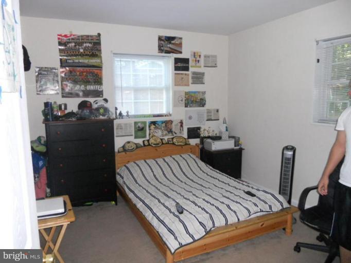 10506 Royal Road Silver Spring, MD 20903 - Photo 11 of 11 a bed sitting in a bedroom next to a window