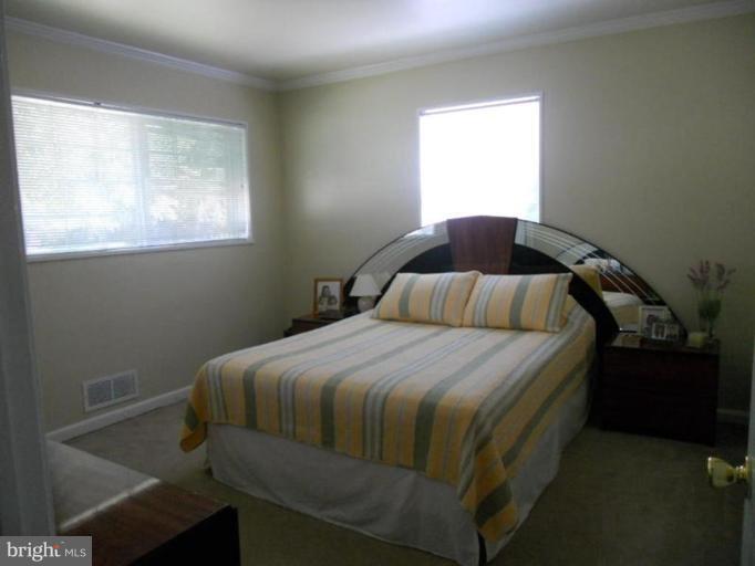 10506 Royal Road Silver Spring, MD 20903 - Photo 3 of 11 a bedroom with a bed and window
