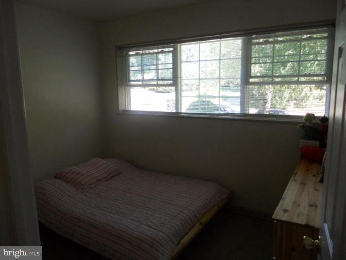 10506 Royal Road Silver Spring, MD 20903 - Photo 5 of 11 a bed sitting in a bedroom next to a window