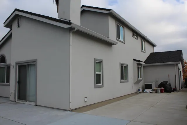 a living room with furniture a lamp and a window