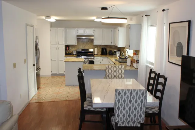 a kitchen with sink a stove top oven and cabinets