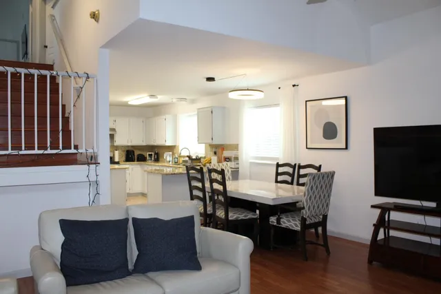 a kitchen with granite countertop a stove a sink a refrigerator and cabinets