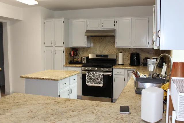 a living room with furniture a fireplace and a window