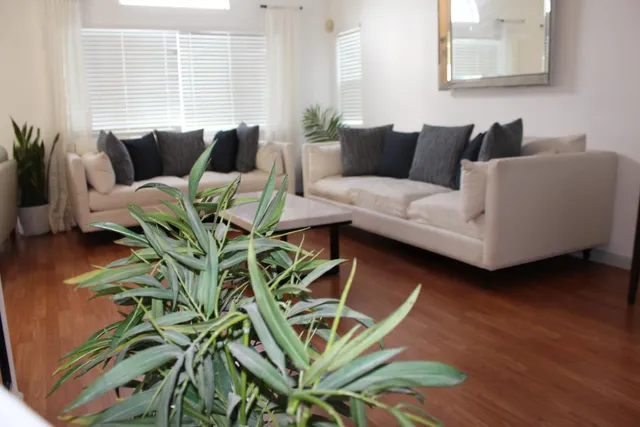 a living room with furniture a large window and a fireplace