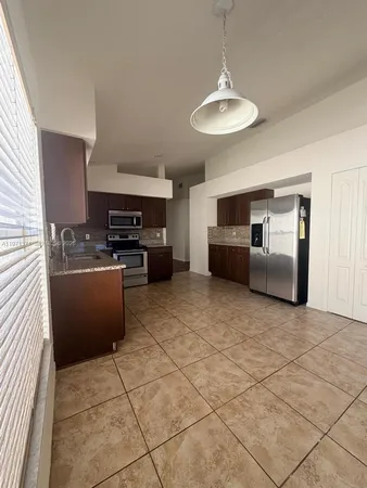 a kitchen with stainless steel appliances granite countertop a sink and cabinets