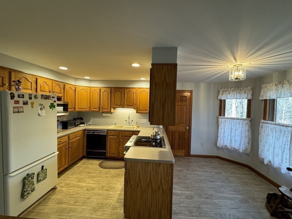 400 N Road Westfield, MA 01085 - Photo 11 of 27 a kitchen with a refrigerator and a stove top oven