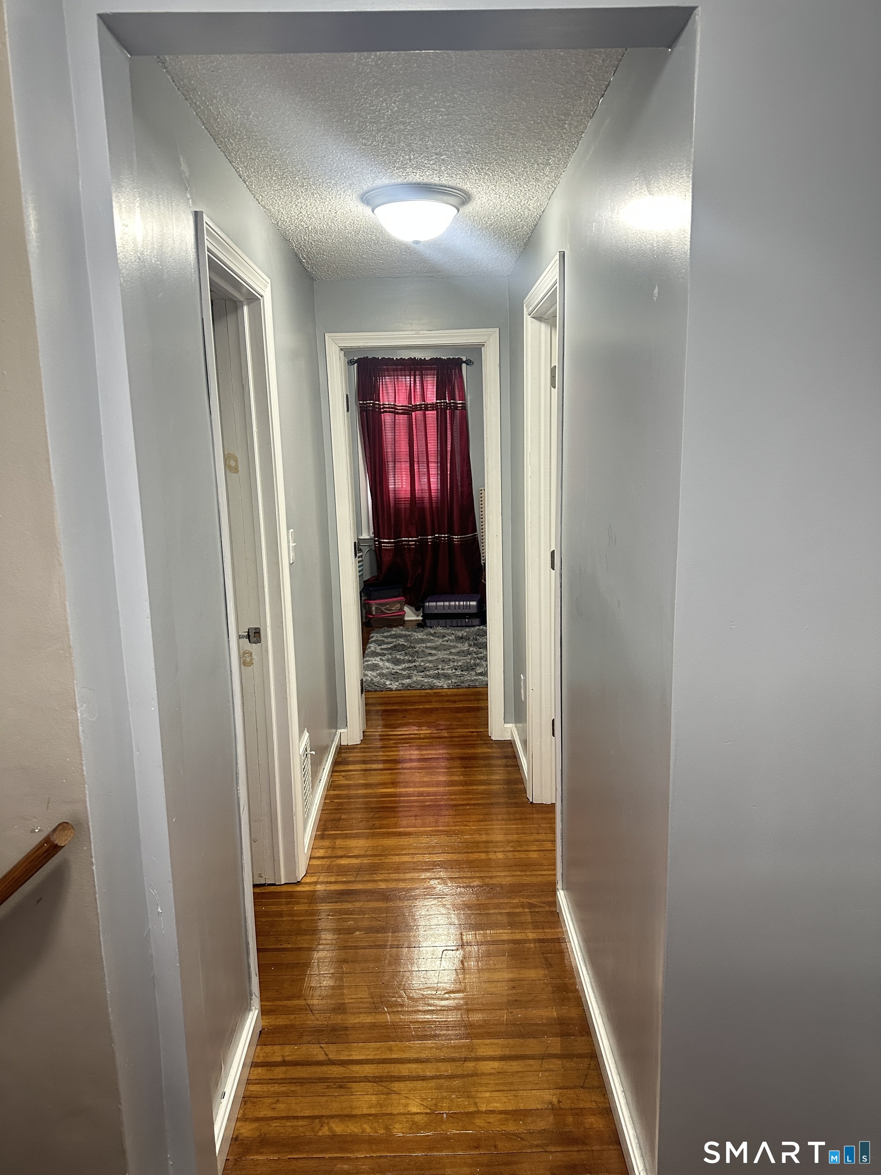 83 Faneuil Street Windsor, CT 06095 - Photo 9 of 14 a view of a hallway with wooden floor and closet