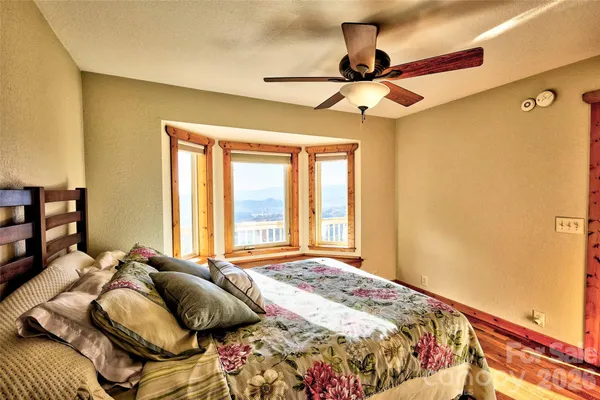 a bed sitting in a bedroom next to a window